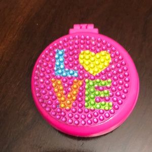 A mirror that comes with a brush